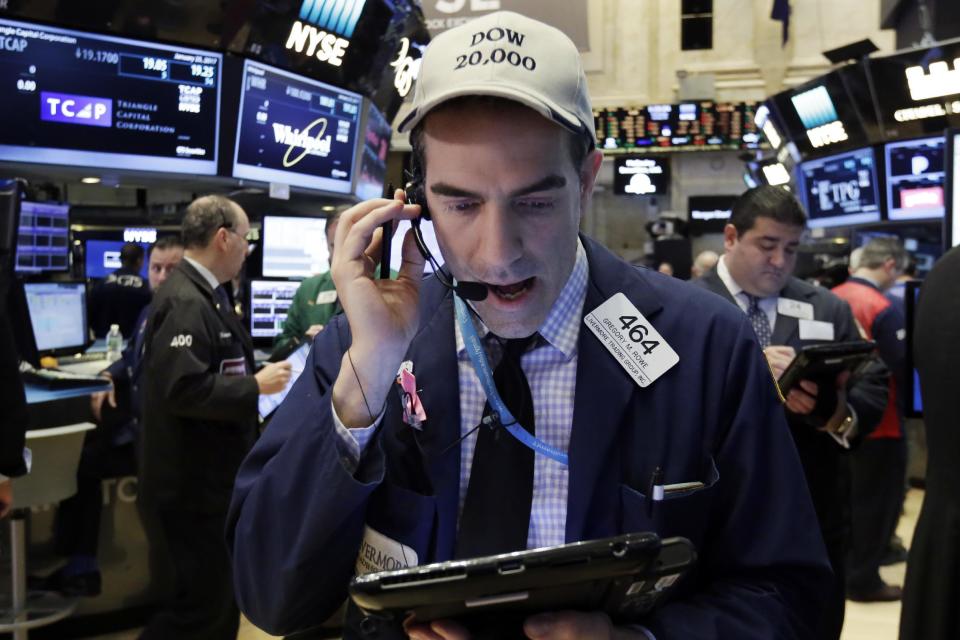 Trader Gregory Rowe wears a Dow 20,000 cap as he works on the floor of the New York Stock Exchange, Wednesday, Jan. 25, 2017. The Dow Jones industrial average is trading over 20,000 points for the first time, the latest milestone in a record-setting drive for the stock market. The market has been marching steadily higher since bottoming out in March 2009 in the aftermath of the financial crisis. (AP Photo/Richard Drew)