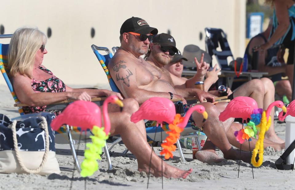 A group of a dozen or so Jeep enthusiasts from Indiana use plastic pink flamingos to mark their presence along Daytona Beach at Wednesday's Jeeps At the Rock event outside Hard Rock Hotel. The two-day Jeeps At the Rock event continues on Thursday as part of the 10-day Jeep Beach gathering.