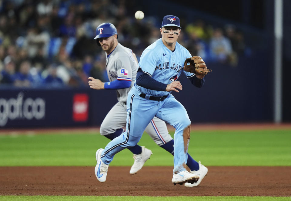 FILE - Toronto Blue Jays third baseman Matt Chapman prepares to field a grounder by Texas Rangers' Ezequiel Duran, as Robbie Grossman runs to third during the fifth inning of a baseball game Thursday, Sept. 14, 2023, in Toronto. Duan was out at first. Chapman won a fourth Gold Gloves, in news announced Sunday, Nov. 5, by Rawlings. (Nathan Denette/The Canadian Press via AP, File)