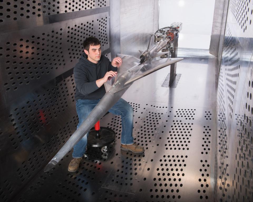 Glenn Research Center technician prepares the QueSST experimental aircraft for testing in the wind tunnel. <cite>NASA</cite>