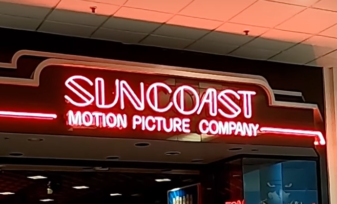 A Suncoast Motion Picture Company sign