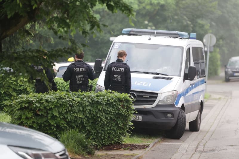 Police stand on a street in Duisburg where an apartment is being searched, as part of action taken against a group allegedly supporting Hamas. The raid comes as the Ministry of the Interior in North Rhine-Westphalia on 16 May also banned the Palestine Solidarity Duisburg. David Young/dpa