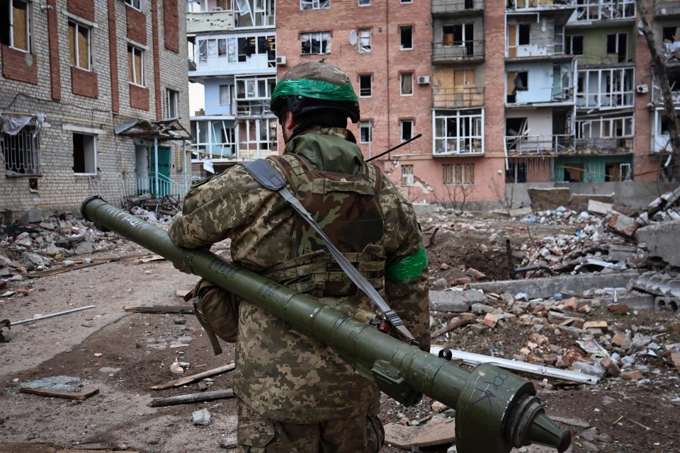 Ukrainian soldier carries a portable anti-aircraft missile system in Bakhmut (AP)