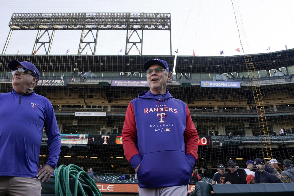 Texas Rangers manager Bruce Bochy, center, walks out of the dugout for batting practice for the team's baseball game against the San Francisco Giants, Friday, Aug. 11, 2023, in San Francisco. (AP Photo/Godofredo A. Vásquez)