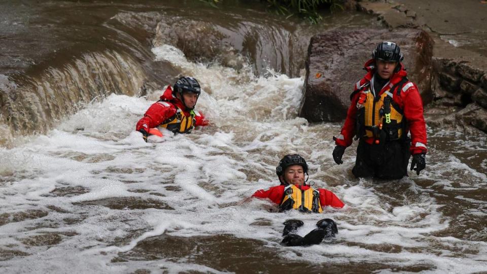 San Luis Obispo city firefighters Travis Robertson, left, Dusty Renner and Armando Gutierrez practice water rescue maneuvers in San Luis Obispo Creek on Wednesday, Dec. 20, 2023, as part of their Urban Search and Rescue training.