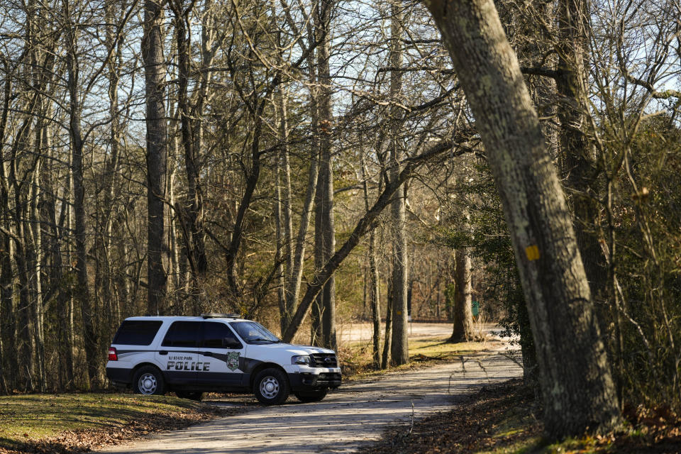 A police vehicle is parked on a road leading to the scene of a helicopter crash in Washington Township, N.J., Wednesday, Dec. 20, 2023. Investigators are examining the wreckage of a TV news helicopter that crashed in the New Jersey Pinelands, killing the pilot and a photographer on board. WPVI-TV of Philadelphia says a two members of its news team were in the helicopter when it went down about 8 p.m. Tuesday in Wharton State Forest. (AP Photo/Matt Rourke)