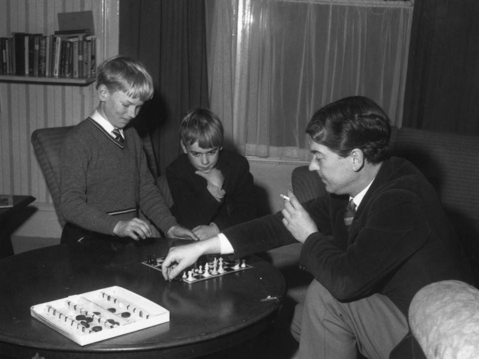 English poet and novelist Kingsley Amis with his sons Martin (left) and Philip playing chess, 1961 (Getty Images)