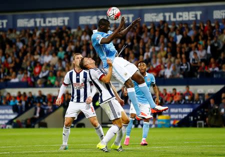 Football - West Bromwich Albion v Manchester City - Barclays Premier League - The Hawthorns - 10/8/15 Manchester City's Yaya Toure in action with West Brom's James Chester Reuters / Darren Staples