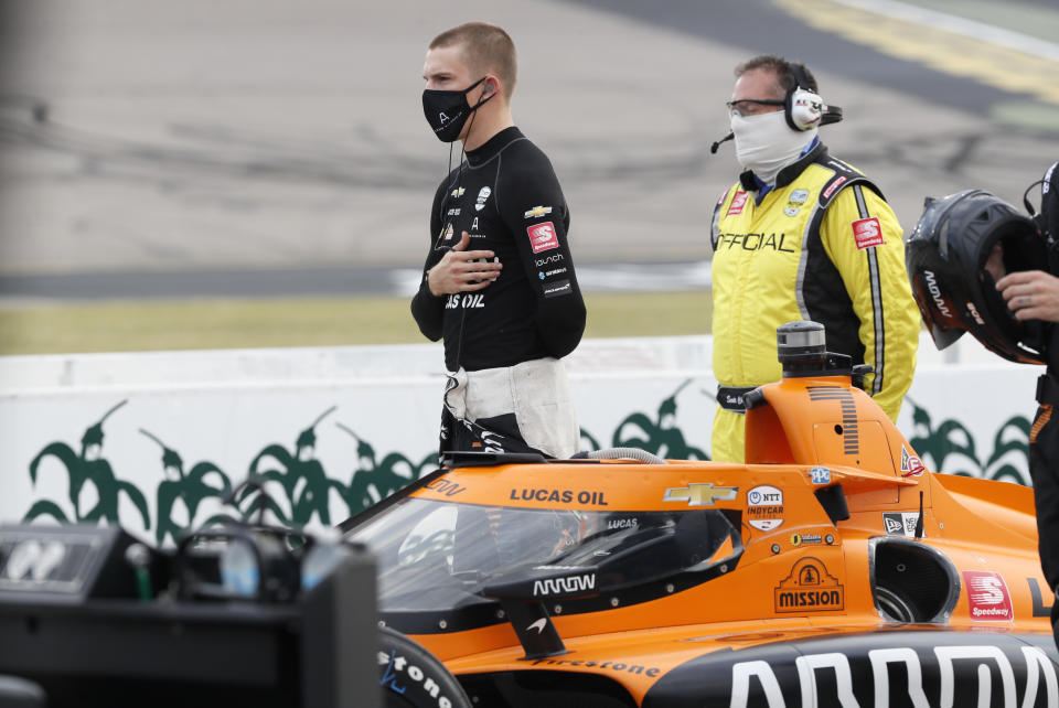 Oliver Askew stands next to his car during the national anthem before IndyCar Series auto race, Saturday, July 18, 2020, at Iowa Speedway in Newton, Iowa. (AP Photo/Charlie Neibergall)