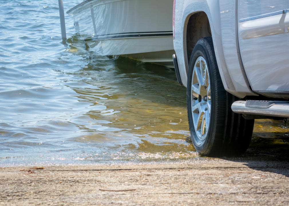 Close up of a truck pulling in a boat.