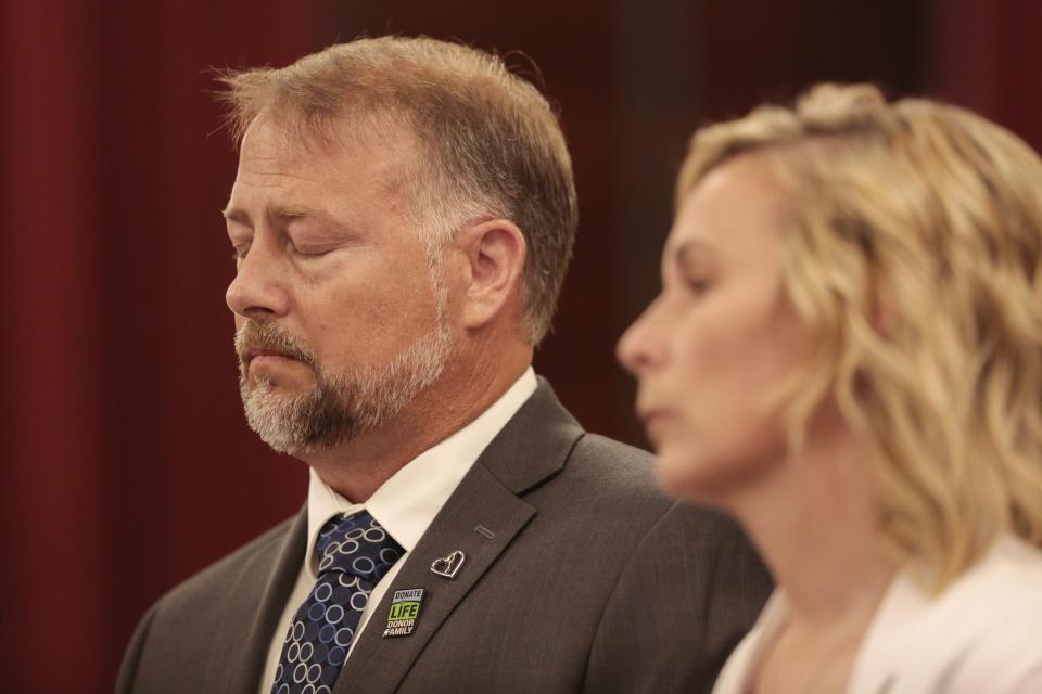 Cory Foltz, left, pauses while testifying with his wife, Shari, in support of an anti-hazing bill at the Ohio Statehouse in Columbus on May 26, 2021.