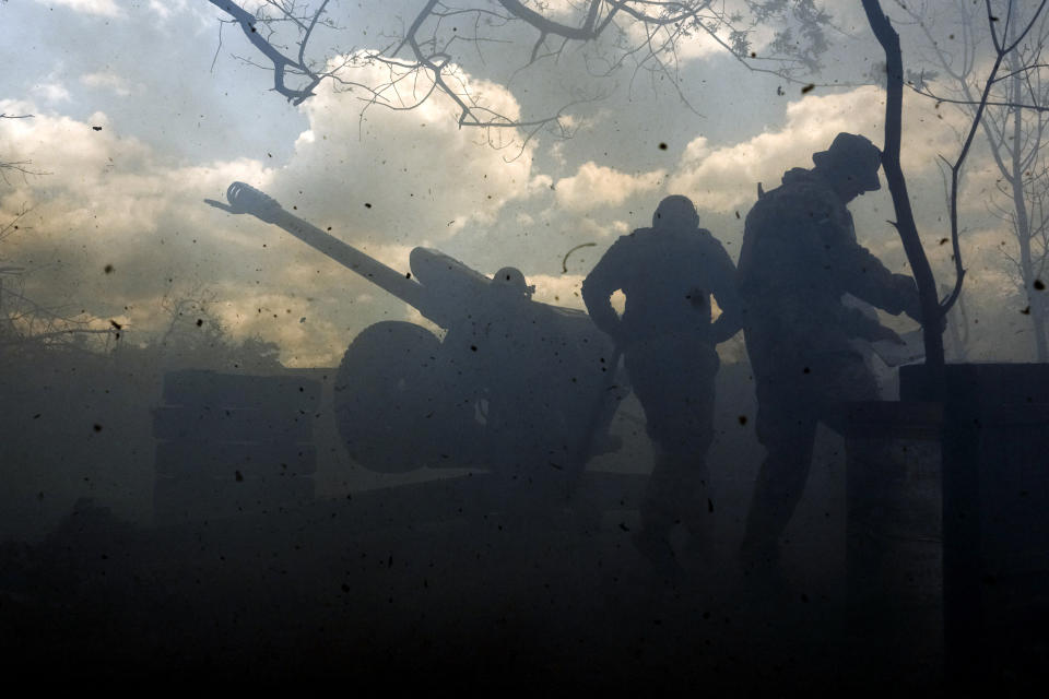 FILE - Ukrainian soldiers fire a cannon near Bakhmut, an eastern city where fierce battles against Russian forces have been taking place, in the Donetsk region, Ukraine, Friday, May 12, 2023. Ukrainian President Volodymyr Zelenskyy said Sunday, May 21, 2023 that Russian forces weren't occupying Bakhmut, casting doubt on Moscow's insistence that the eastern Ukrainian city had fallen. The fog of war made it impossible to confirm the situation on the ground in the invasion’s longest battle, and the comments from Ukrainian and Russian officials added confusion to the matter. (AP Photo/Libkos, File)