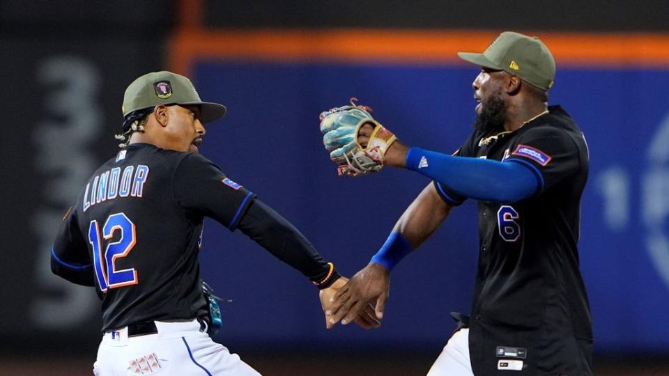 May 21, 2023; New York City, New York, USA; New York Mets shortstop Francisco Lindor (12) and right fielder Starling Marte (6) low five to celebrate the victory after the game against the Cleveland Guardians at Citi Field.