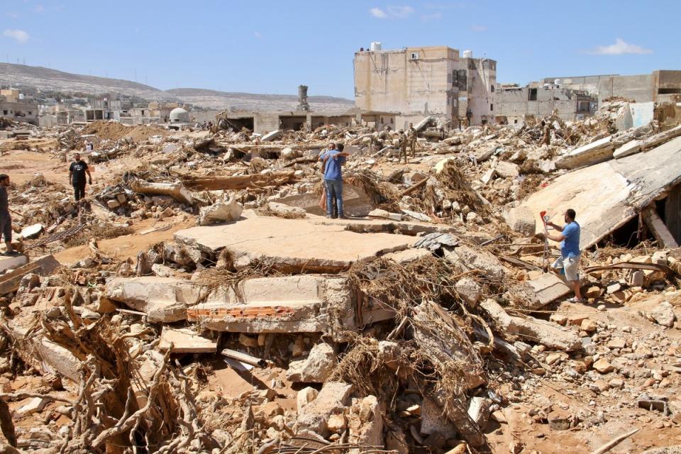 People look for survivors in Derna on Sept.13. Search teams are combing streets, wrecked buildings, and even the sea to look for bodies in Derna.<span class="copyright">Yousef Murad—AP</span>