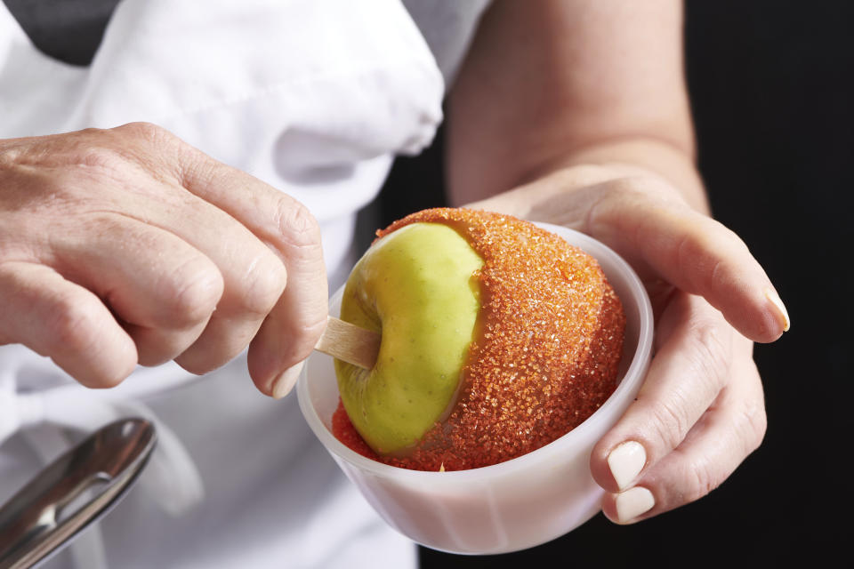 Caramel apples are prepared in New York in October 2020. Homemade caramel apples are surprisingly easy to make. You can use whatever apples you like, as long as they are firm and crisp (Cheyenne M. Cohen via AP)