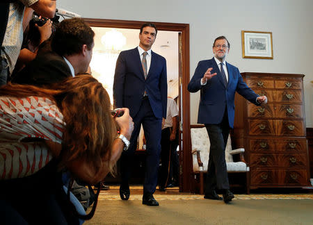 Spain's acting Prime Minister Mariano Rajoy (R) and Spain's Socialist Party (PSOE) leader Pedro Sanchez arrive for their meeting at parliament in Madrid, Spain, August 29, 2016. REUTERS/Andrea Comas