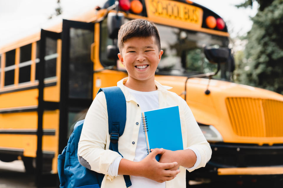 kid getting off the school bus on the first day of school