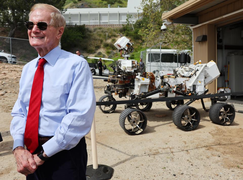 NASA Administrator Bill Nelson stands next to a full scale model of the Perseverance rover in April during a tour with members of Congress highlighting current and future missions, including one to bring samples of Martian terrain back to Earth.