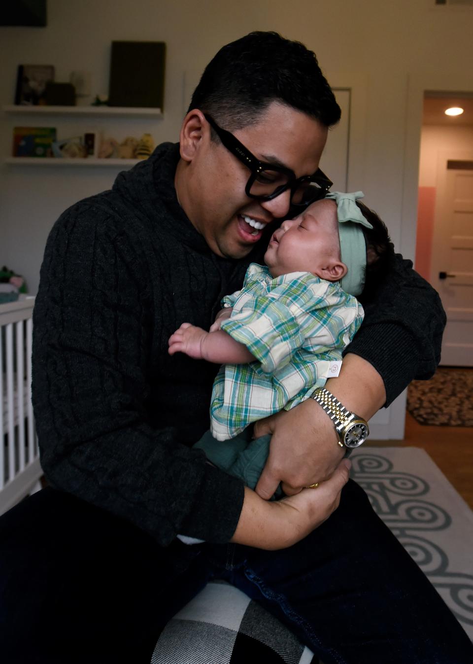 Renowned Nashville Chef Arnold Myint cuddles his daughter, Henley, on Tuesday, Nov. 21, 2023, in Nashville, Tenn. Myint, who had Henley through surrogacy, discusses being a single, gay dad in Tennessee.