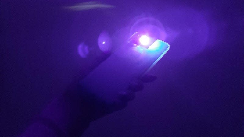 A homemade 'Purple Light' made by pasting cellophane over a smartphone's flashlight.