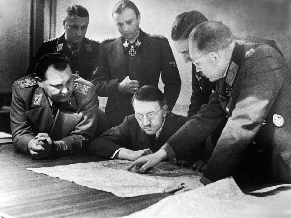 Adolf Hitler (center, in glasses) and members of his General Staff review plans for 'Operation Bodenplatte' (also known as 'the Great Blow'), an airstrike in support of the Ardennes offensive, late 1944.<span class="copyright">Heinrich Hoffman/The LIFE Picture Collection—Getty Images</span>