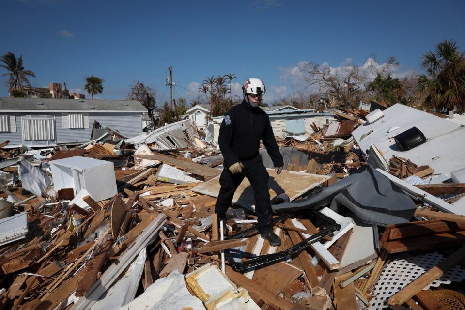 A rescue worker searches for Hurricane Ian victims in Fort Myers Beach on Tuesday (Getty Images)