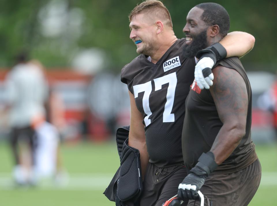 Cleveland Browns offensive linemen Wyatt Teller, left, and Chris Hubbard head to the locker room after working out in training camp on Friday, July 29, 2022 in Berea.