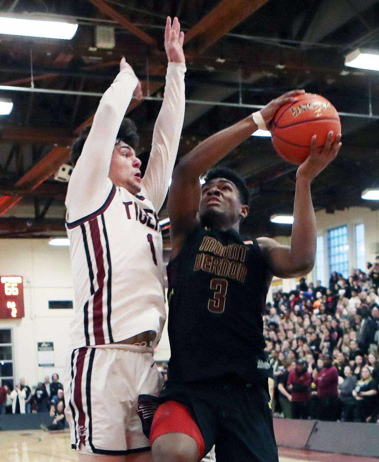 Mt. Vernon's Nate Edwards (3) tries to put a shot over Kingston's Derek Constance (1) during the state regional final at Kingston High School March 8, 2024. Kingston won the game 81-78.