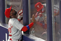 Philadelphia Phillies left fielder Andrew McCutchen (22) tracks the path of Gio Urshela's sixth-inning, three-run home run as Phillies catrching coach Greg Brodzinski ducks in the bullpen in a baseball game against the New York Yankees, Monday, Aug. 3, 2020, at Yankee Stadium in New York. (AP Photo/Kathy Willens)