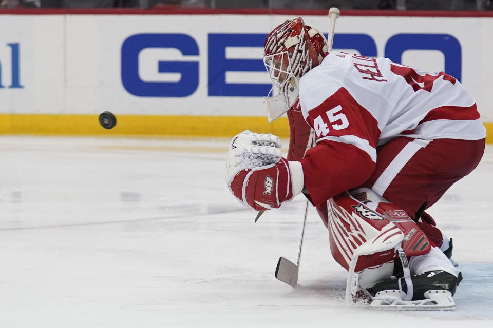 Detroit Red Wings goaltender Magnus Hellberg makes a save during the third period of an NHL hockey game against the New Jersey Devils in Newark, N.J., Friday, April 29, 2022. The Red Wings defeated the Devils 5-3. (AP Photo/Seth Wenig)
