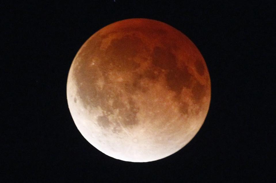 A shadow falls on the moon as it undergoes a total lunar eclipse as seen from Mexico City April 15, 2014. (REUTERS/Edgard Garrido)