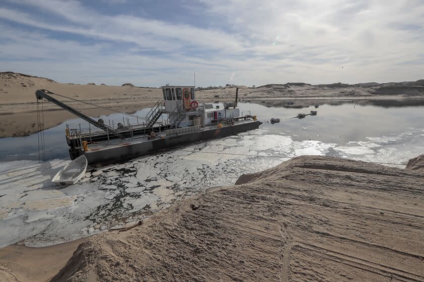 MARINA, CA, WEDNESDAY, JANUARY 26, 2020 - A dredging vessel floats in a pool on the sand of the Marina Dunes, where a Cemex processing plant continues to operate. (Robert Gauthier/Los Angeles Times)