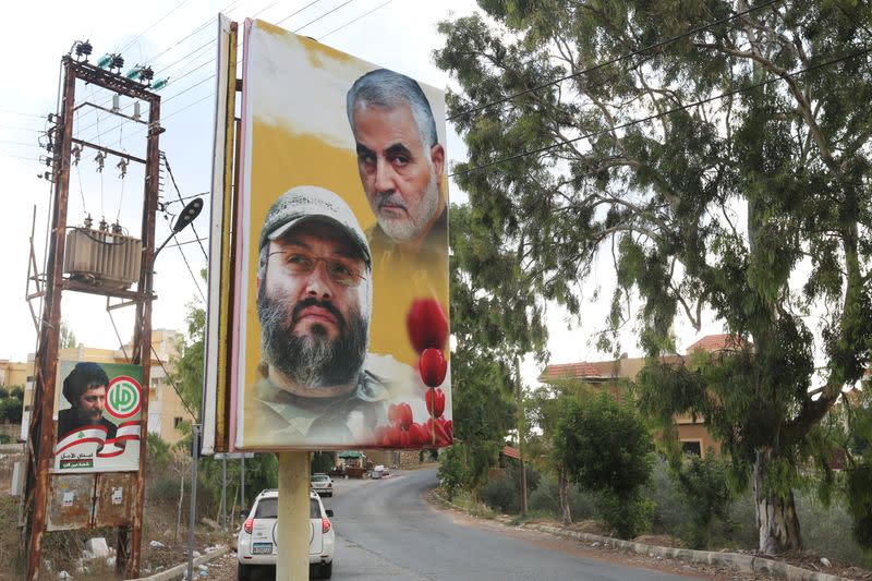 An ambulance drives trough the village of Ain Qana, in Lebanon