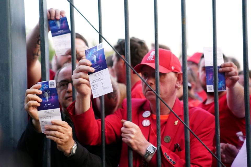Liverpool fans stuck outside the ground show their match tickets (Adam Davy/PA) (PA Wire)