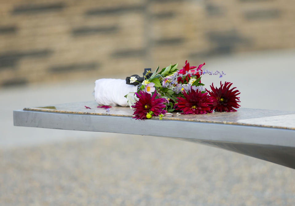 Flowers sit on one of the benches of the Pentagon Memorial at the at the Pentagon, Thursday, Sept. 11, 2014. President Barack Obama will attend the  wreath laying later this morning to to mark the 13th anniversary of the 9/11 attacks. (AP Photo/Pablo Martinez Monsivais)