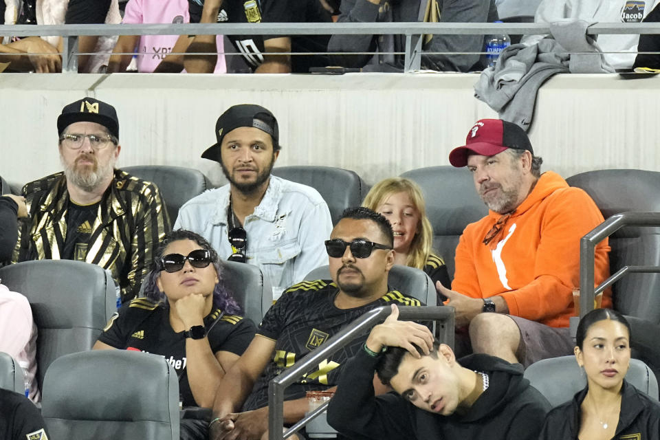 Actor Jason Sudeikis, right, sits with actor Brendan Hunt, left, during the first half of a Major League Soccer match between Los Angeles FC and Inter Miami Sunday, Sept. 3, 2023, in Los Angeles. (AP Photo/Mark J. Terrill)