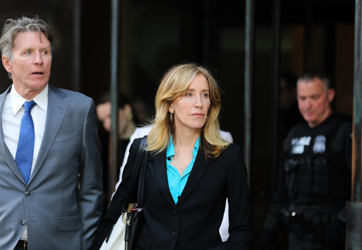 Actress Felicity Huffman, center, leaves the John Joseph Moakley United States Courthouse in Boston on April 3, 2019. (Photo by Pat Greenhouse/The Boston Globe via Getty Images)