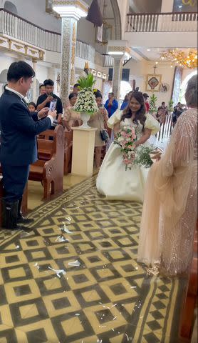 <p>Maria Jasmin Halili/Facebook</p> Bride Walks Down Flooded Aisle After Typhoon in the Philippines