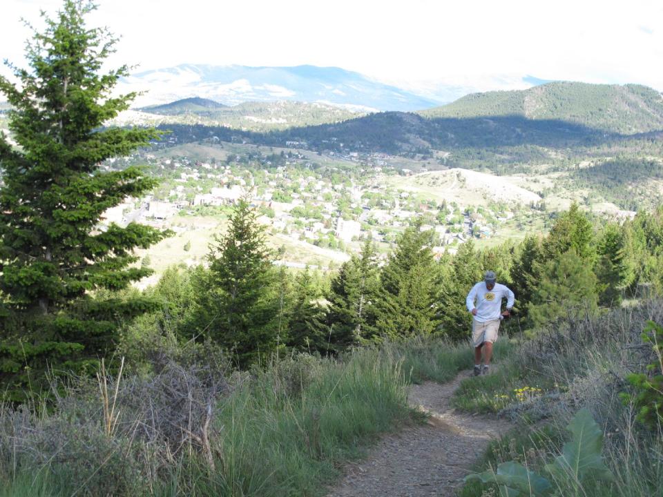 This June 9, 2012 photo shows a jogger runs along a trail on Mount Helena on June 9, 2012, in Helena, Mont. The Helena Ridge Trail, which ends at the 5,400-foot summit of Mount Helena, is one of the Montana capital's top attractions. (AP Photo/Matt Volz)