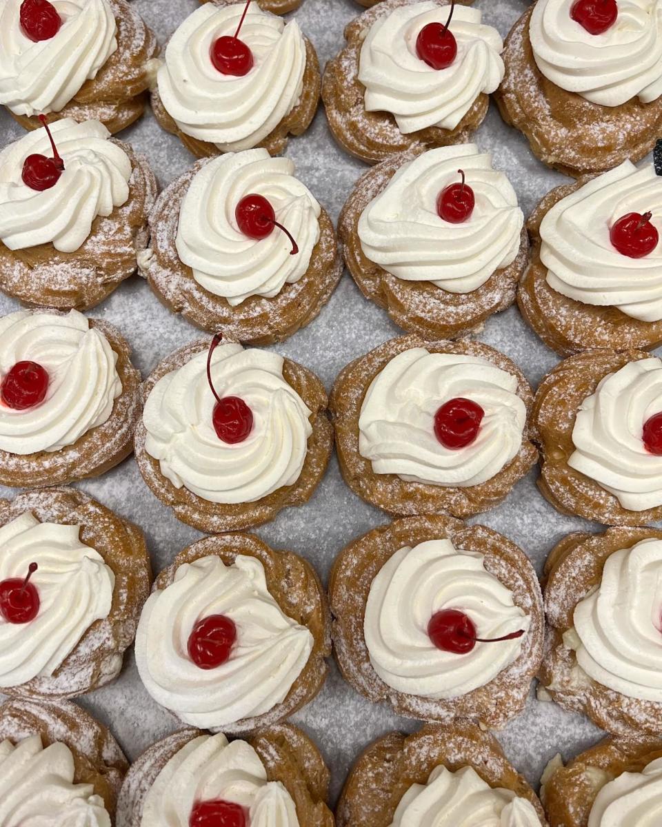 Traditional zeppole at Wright's Dairy Farm and Bakery in North Smithfield, have a blend of house-made creamy custard, ricotta cheese and rum flavoring. They are topped with whipped cream and a cherry.