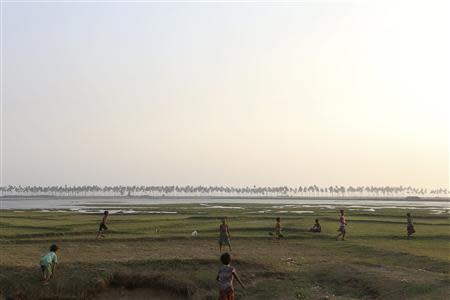 Children play in the fields near the Dar Paing camp for internally displaced people in Sittwe, Rakhine state, April 24, 2014. REUTERS/Minzayar
