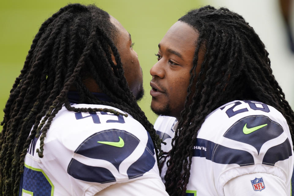 Seattle Seahawks outside linebacker Shaquem Griffin (49) and teammate cornerback Shaquill Griffin (26) greeting each other before the start of the first half of an NFL football game against the Washington Football Team, Sunday, Dec. 20, 2020, in Landover, Md. (AP Photo/Andrew Harnik)