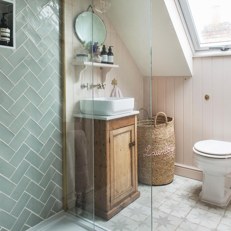 Bathroom with wooden storage cabinet under sink and shower