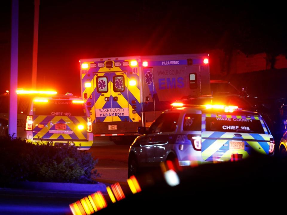 An ambulance believed to be carrying a shooting suspect arrives at Wake Medical Center Emergency Room in Raleigh, N.C., Thursday, Oct. 13, 2022, surrounded by police (AP)