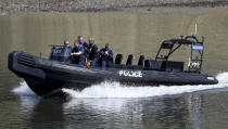 Police patrol the River Thames prior to the annual university Oxford-Cambridge boat race along the river , London, Sunday April 2, 2017. Police have said the annual event will go ahead after a World War II era bomb was safely removed from the shallows of the river near to the start of the race at Putney Bridge in southwest London. (Andrew Matthews/PA Wire(/PA via AP)