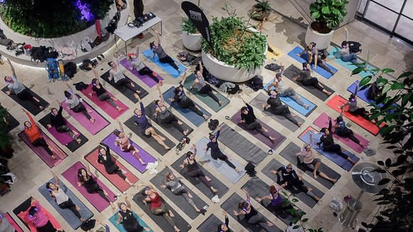 Group of people on exercise mats during a yoga class.