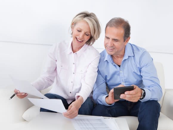 A couple happily looking over paperwork.