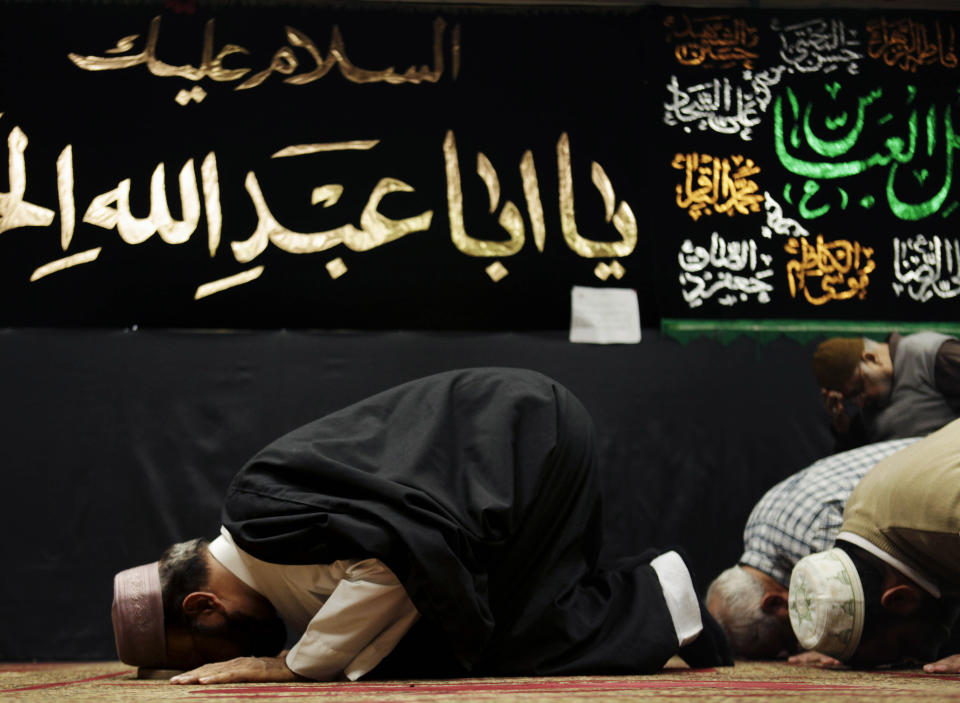 FILE - In this Feb. 1, 2012, file photo, Imam Malik Sakhawat Hussain, left, leads prayers at the Al-Mahdi Foundation in New York. As it canvassed the Northeast looking for Iranian terrorists, the New York Police Department recommended increasing surveillance of thousands of Shiite Muslims and their mosques based solely on their religion. On Tuesday, April 15, 2014, the New York City Police Department confirmed that it has disbanded the special unit that conducted surveillance on Muslim communities in both New York and New Jersey. (AP Photo/Seth Wenig, File)