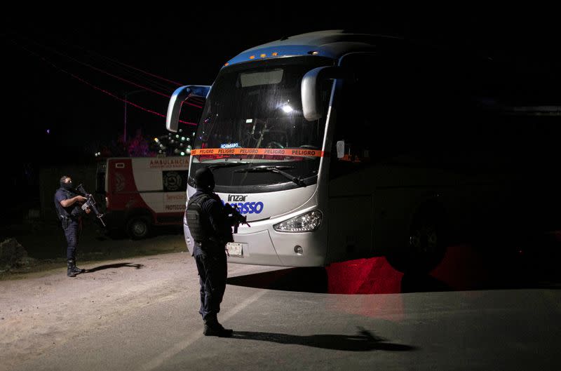 Police keep watch at a scene where 19 people were killed, in Zinapecuaro