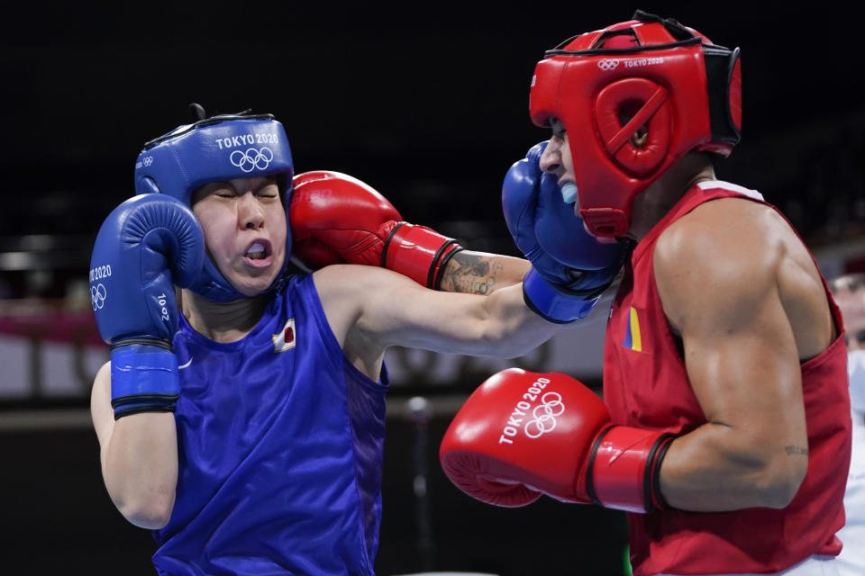 Japan's Sena Irie, left, punches Romania's Maria Nechita during their women's featherweight 57-kg boxing match at the 2020 Summer Olympics, Wednesday, July 28, 2021, in Tokyo, Japan. (AP Photo/Frank Franklin II, Pool)